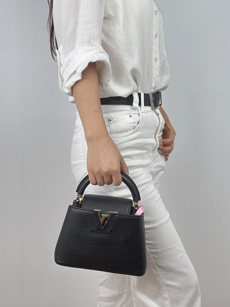 Louis Vuitton Crossbody Bag Capucines Black Calfskin Mini 21 × 8 × 14 cm — on-model view 1 of 2