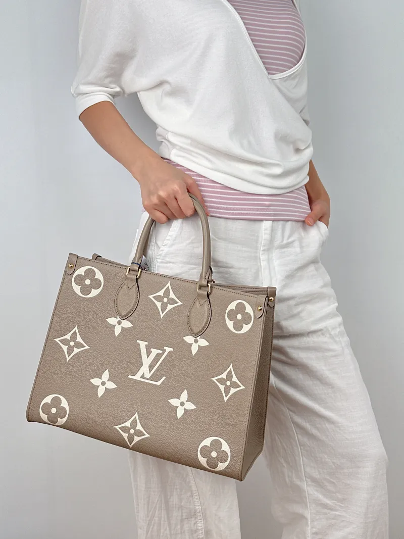 Louis Vuitton Shoulder Bag Onthego Medium · White Empreinte Embossed Calfskin Monogram Medium35 × 14 × 27 cm — on-model view 2 of 2