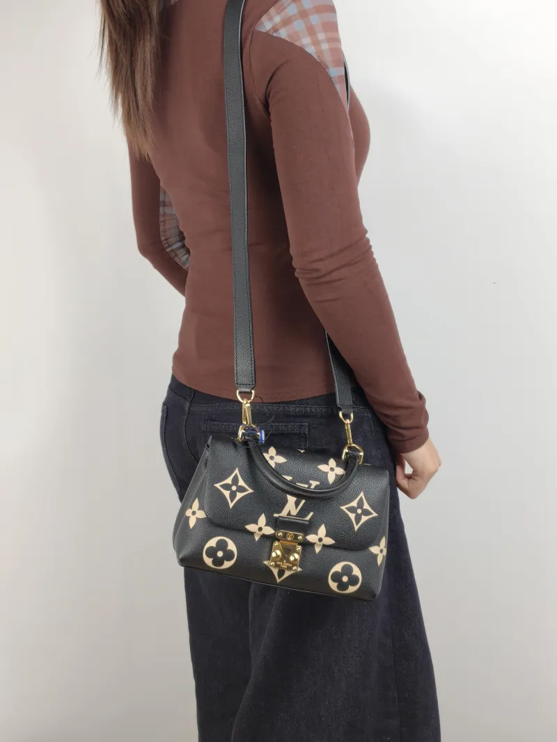 Louis Vuitton Crossbody Bag MADELEINE Black · White Monogram Empreinte Embossed Calfskin BB 24 × 8.5 × 17 cm — on-model view 1 of 3