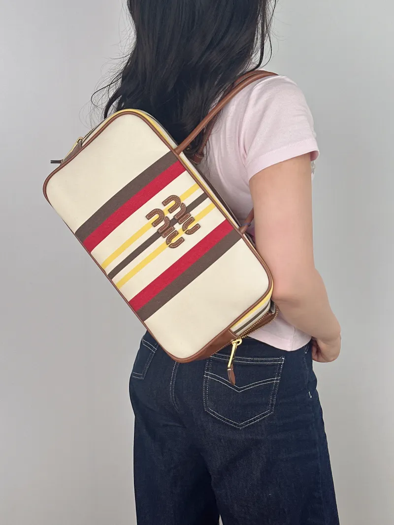 Miumiu Top Handle Bag Beau Canvas Large 34 × 10 × 20 cm — on-model view 1 of 2
