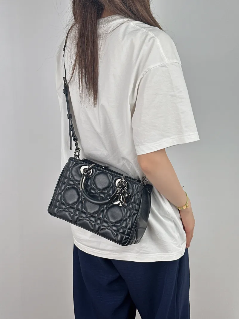 DIOR Top Handle Bag Lady 95.22 Black Calfskin Small25 × 10 × 16 cm — on-model view 1 of 2