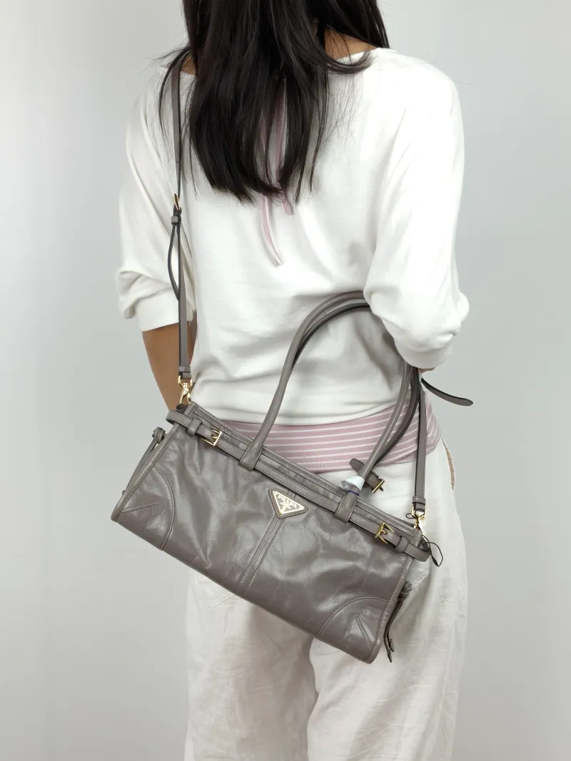 PRADA Shoulder Bag Bonnie Soft Lux Grey Waxed Leather Calfskin Medium 32 × 12 × 15.5 cm — on-model view 2 of 3