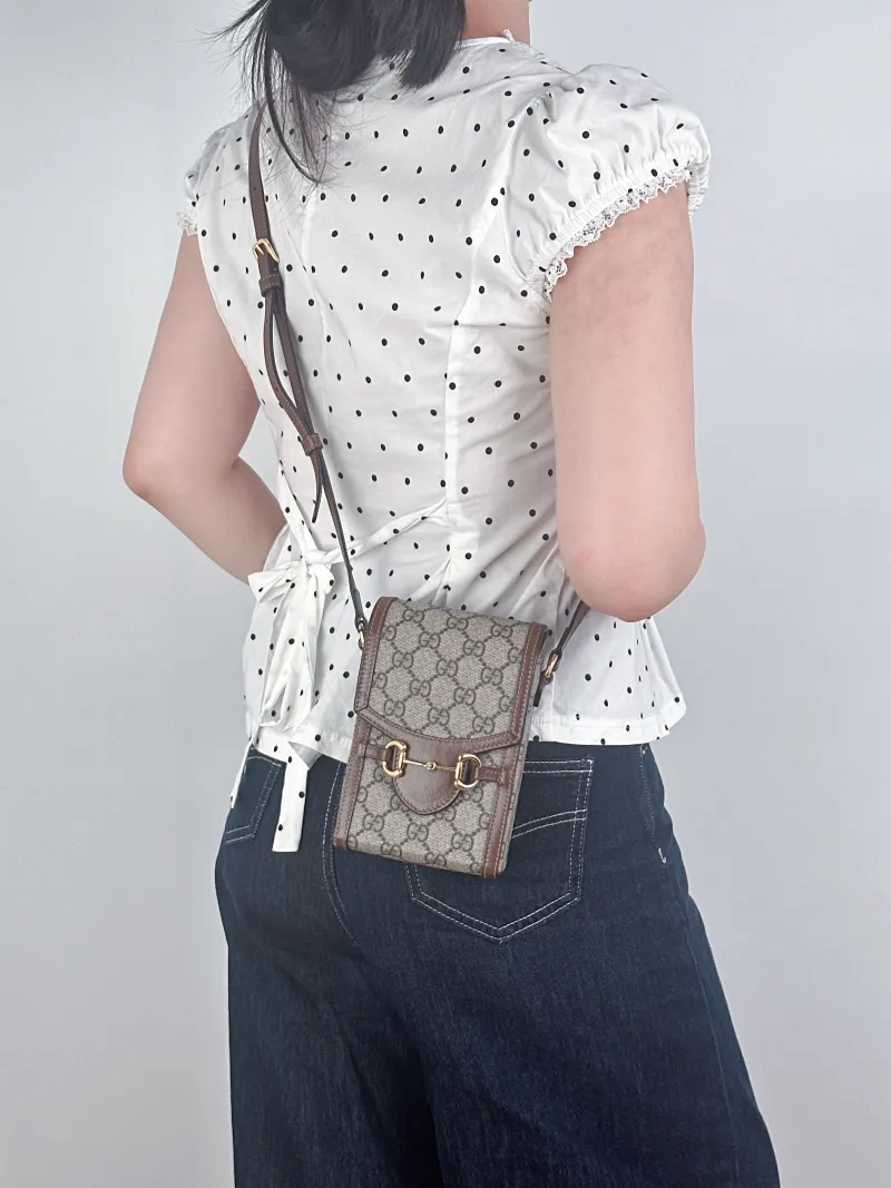 GUCCI Crossbody Bag Horsebit 1955Collection Mini Monogram PV Cmini11.5 × 4 × 17 cm — on-model view 1 of 2