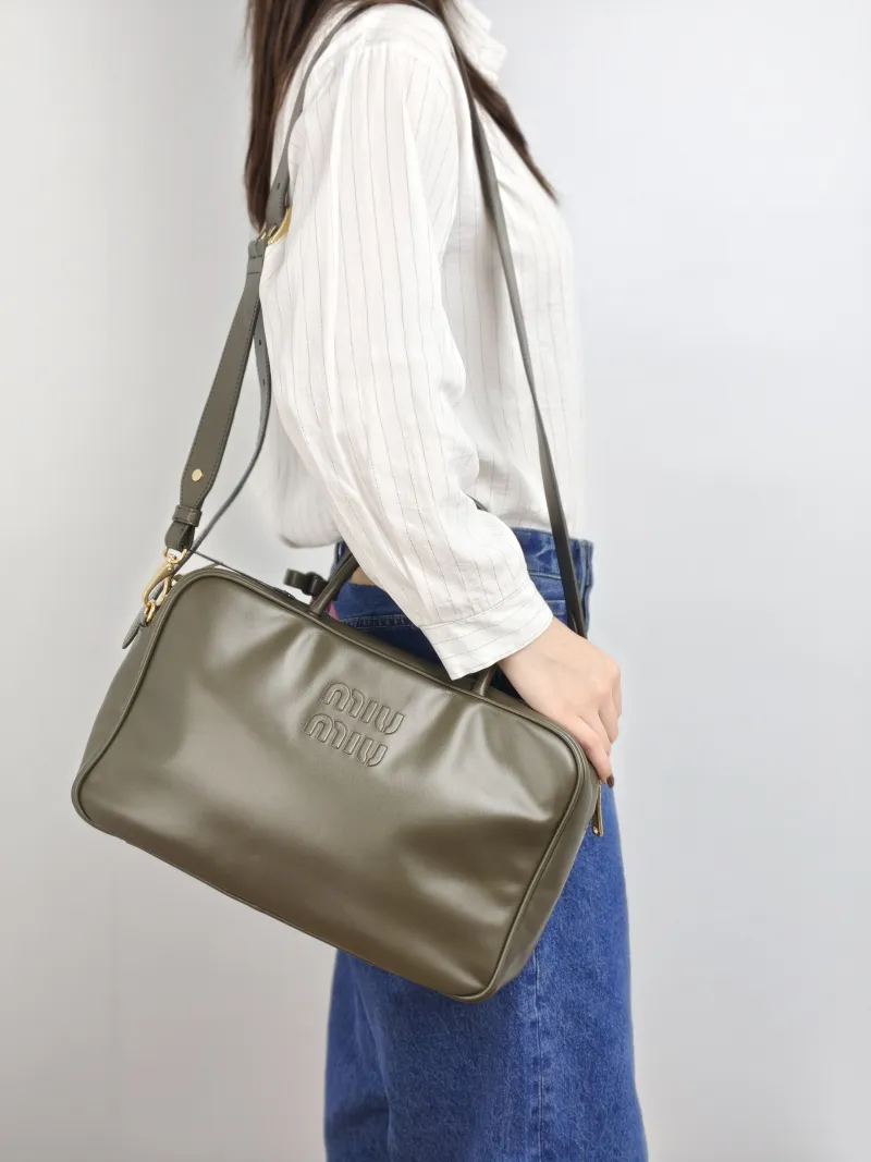 Miumiu Top Handle Bag Beau CC alfskin 34 × 10 × 23 cm — on-model view 2 of 2