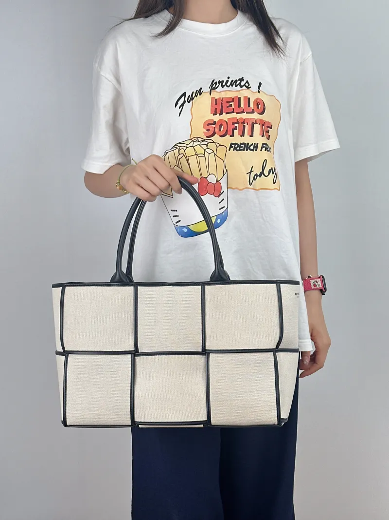 Bottega Veneta Top Handle Bag Arco Woven Tote Bag Beige · Black Canvas Medium36.5 × 14 × 24 cm — on-model view 1 of 2