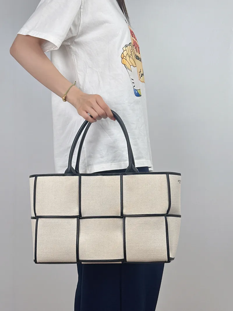 Bottega Veneta Top Handle Bag Arco Woven Tote Bag Beige · Black Canvas Medium36.5 × 14 × 24 cm — on-model view 2 of 2