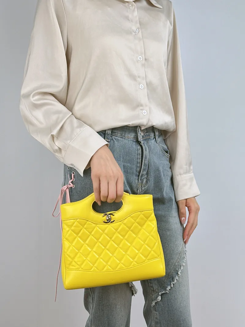 Chanel Crossbody Bag 31Bag Yellow Waxed Leather Mini 23 × 5.5 × 22 cm — on-model view 1 of 3