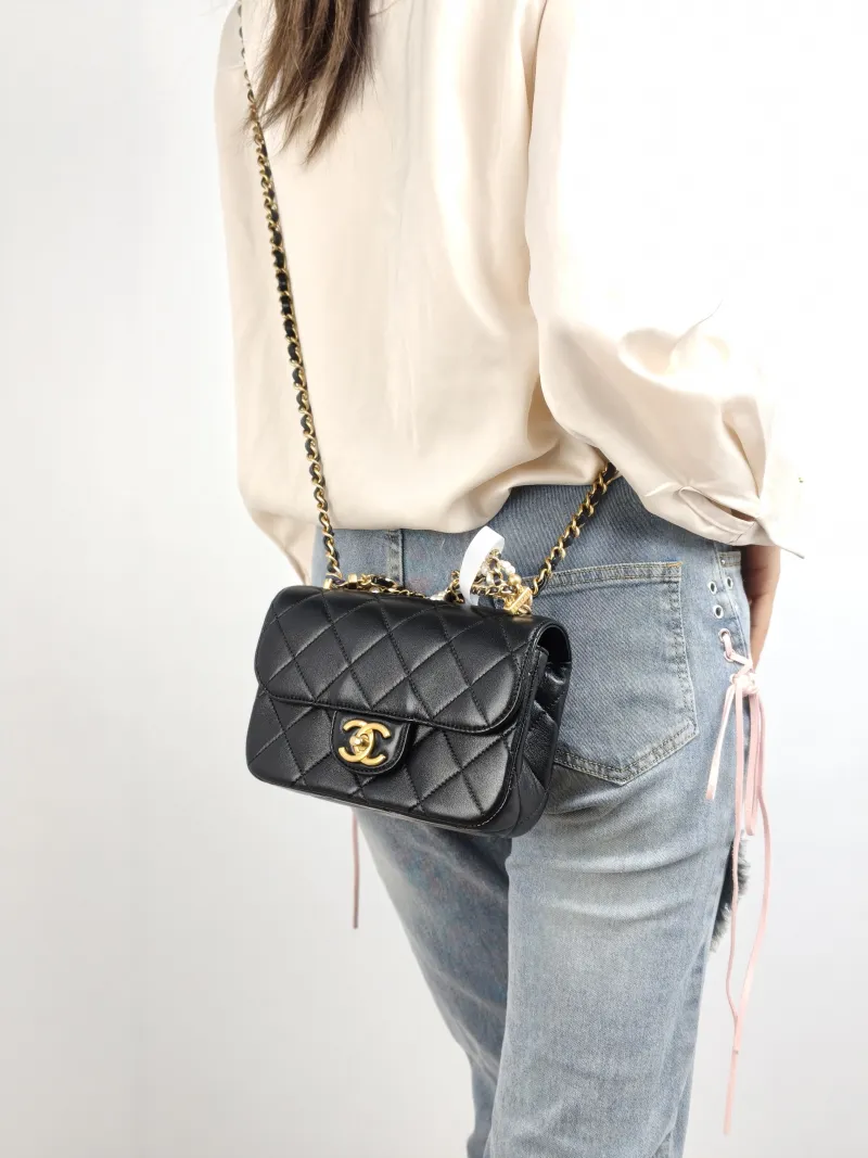 Chanel Crossbody Bag Pearl Black Lambskin Mini 19 × 5.5 × 12.5 cm — on-model view 1 of 2