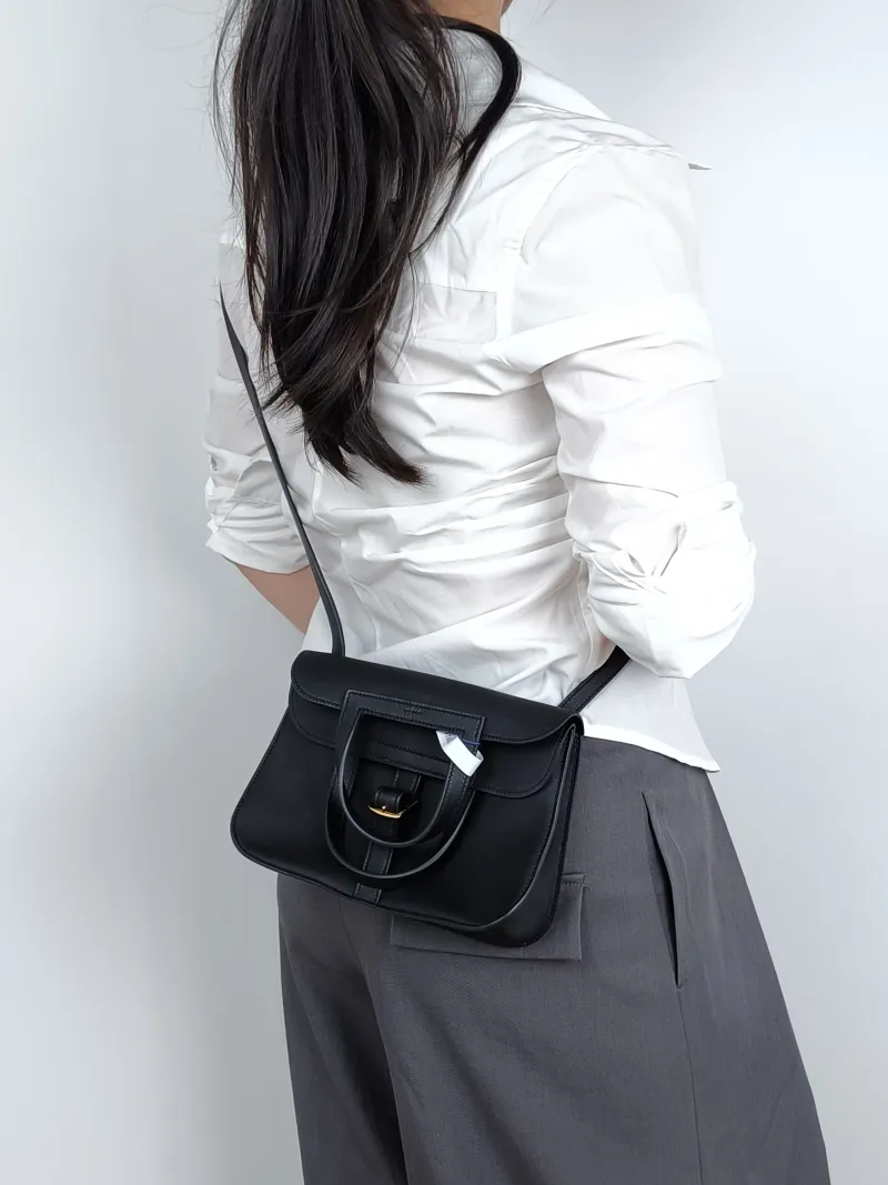Hermès Crossbody Bag Halzan Black Swift Calfskinmini22 × 6.5 × 15 cm — on-model view 2 of 2