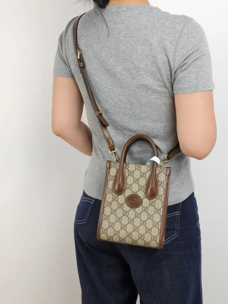 GUCCI Crossbody Bag GG Retro Collection Tote Bag Brown PVC Mini 16 × 7 × 20 cm — on-model view 1 of 2