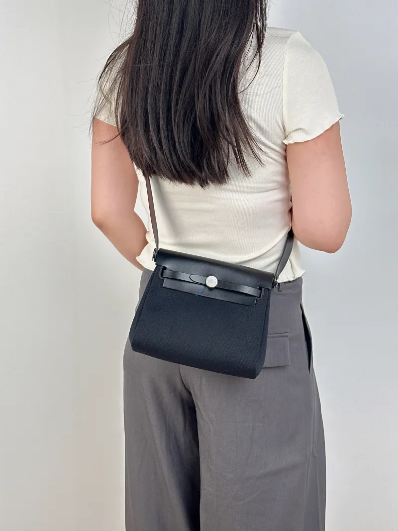 Hermès Crossbody Bag Herbag Zip 20Black Canvas mini20.5 × 7 × 16.5 cm — on-model view 2 of 2