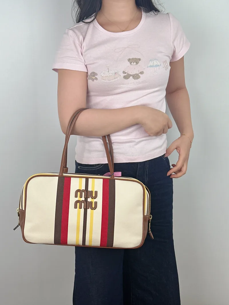 Miumiu Top Handle Bag Beau Canvas Large 34 × 10 × 20 cm — on-model view 2 of 2