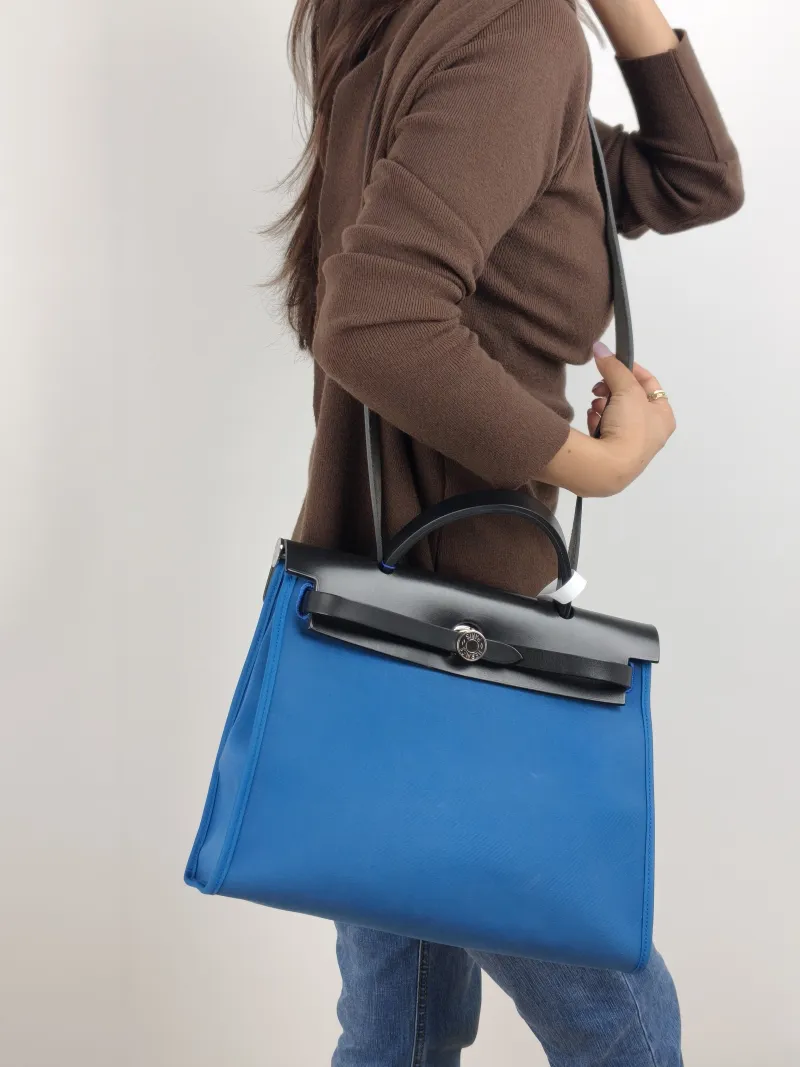 Hermès Crossbody Bag Herbag 31 Blue Black Canvas Medium 30.5 × 11 × 25.5 cm C — on-model view 1 of 2