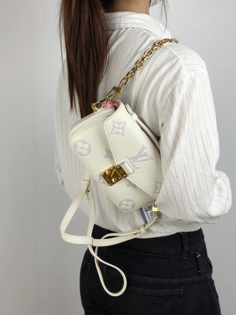 Louis Vuitton Crossbody Bag Pochette Métis East West White · Monogram Empreinte Embossed Calfskin Small 21.5 × 6 × 13.5 cm — on-model view 3 of 3