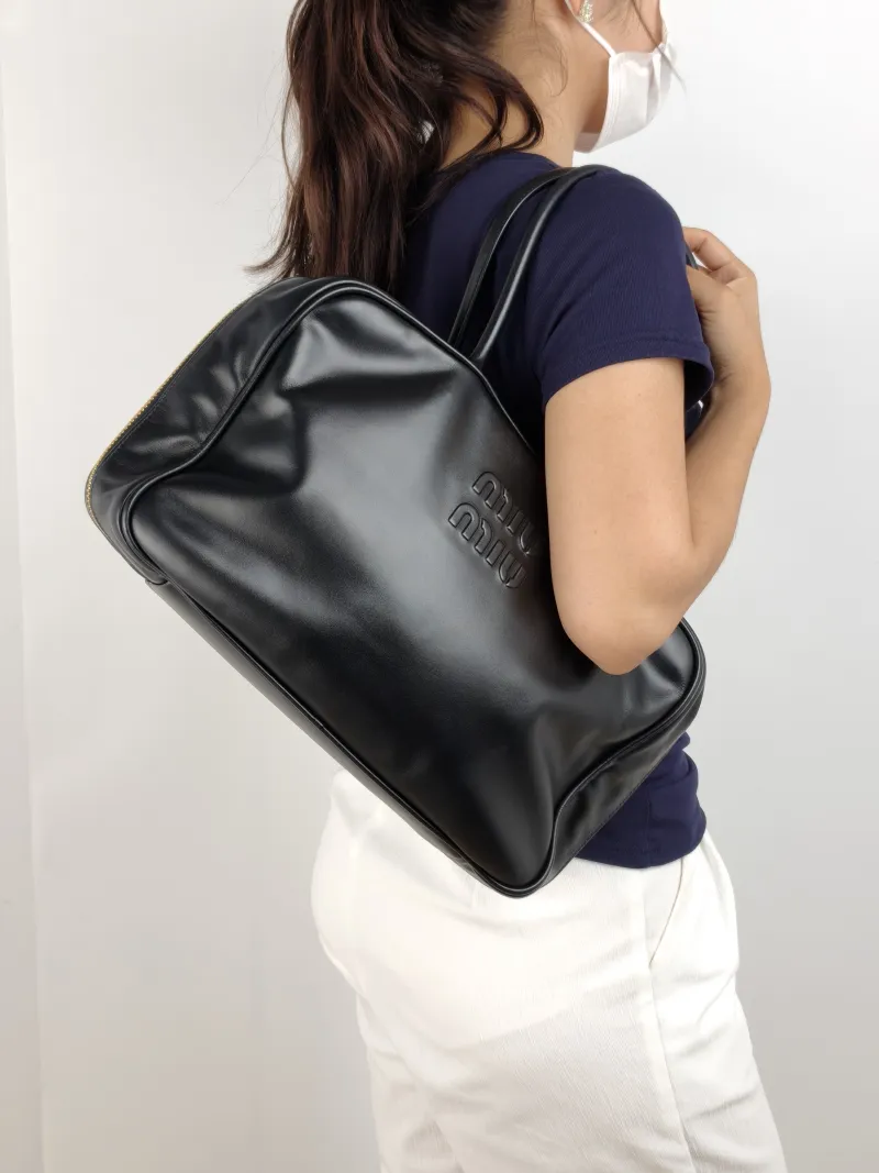 Miumiu Top Handle Bag Beau Black Calfskin Large 34 × 10 × 23 cm — on-model view 1 of 2