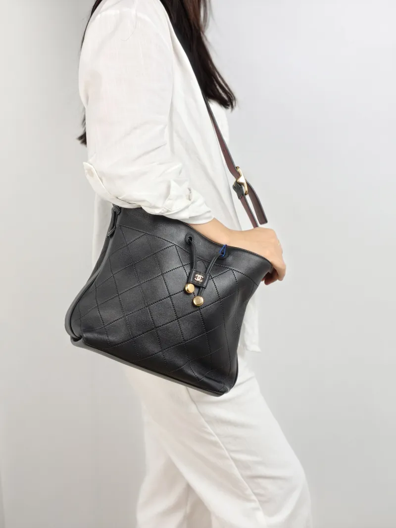 Chanel Shoulder Bag Bucket Bag Black Lambskin 22.5 × 13 × 22 cm — on-model view 1 of 2