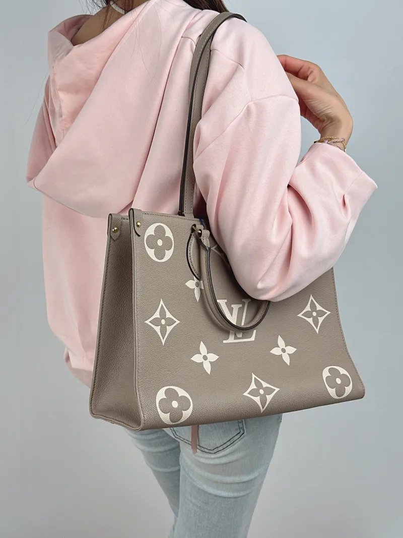 Louis Vuitton Shoulder Bag Onthego Medium · White Monogram Empreinte Embossed Calfskin Medium 35 × 14 × 27 cm — on-model view 1 of 2