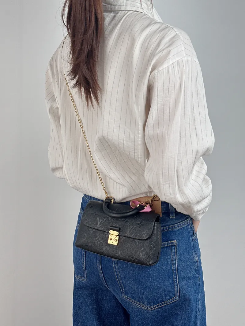 Louis Vuitton Crossbody Bag MADELEINE Black Monogram Empreinte Embossed Calfskin nano 21 × 6 × 12.5 cm — on-model view 1 of 2
