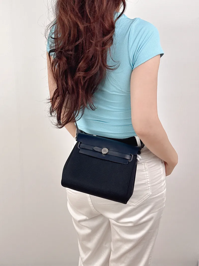 Hermès Crossbody Bag Herbag Zip 20Black Calfskin，Canvasmini20.5 × 7 × 16.5 cm — on-model view 2 of 2