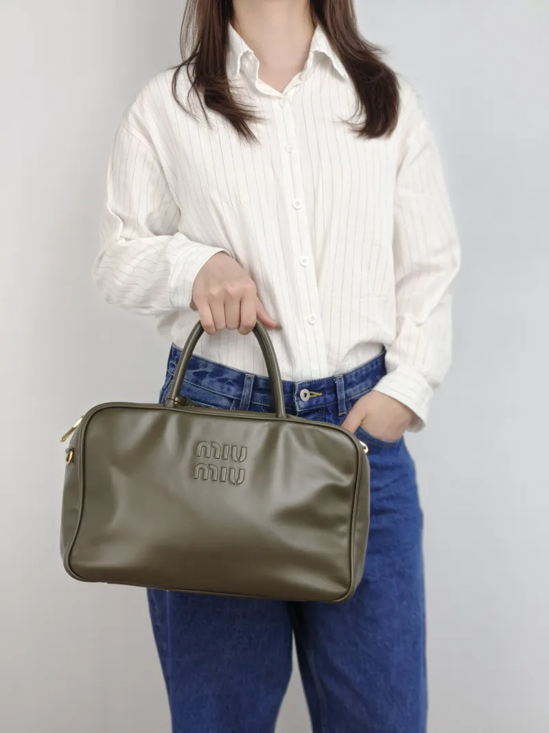 Miumiu Top Handle Bag Beau CC alfskin 34 × 10 × 23 cm — on-model view 1 of 2