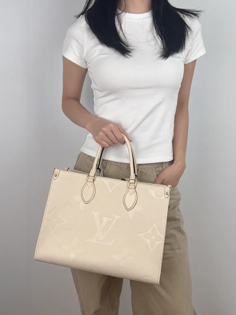 Louis Vuitton Shoulder Bag Onthego Medium White Monogram Empreinte Embossed Calfskin Medium 35 × 14 × 27 cm — on-model view 2 of 2