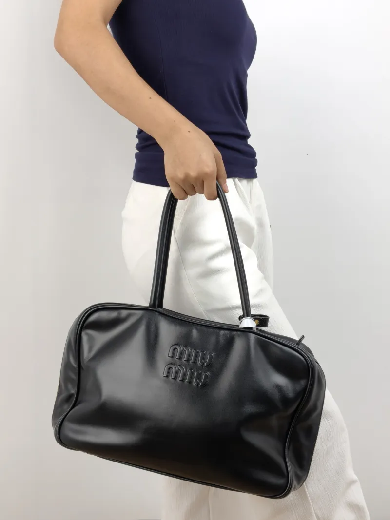Miumiu Top Handle Bag Beau Black Calfskin Large 34 × 10 × 23 cm — on-model view 2 of 2