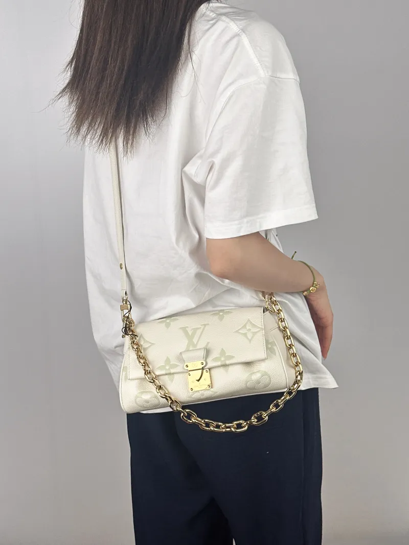 Louis Vuitton Crossbody Bag Favorite White · Green Empreinte Embossed Calfskin Monogram Medium24 × 9 × 14 cm — on-model view 1 of 2