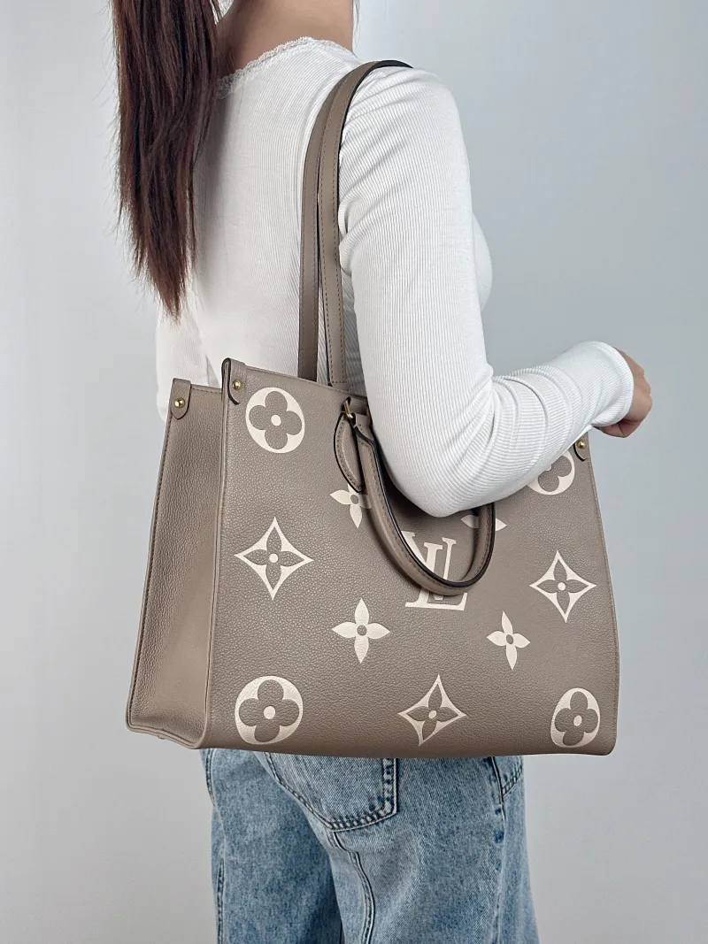 Louis Vuitton Shoulder Bag Onthego Medium · White Monogram Empreinte Embossed Calfskin Medium 35 × 14 × 27 cm — on-model view 1 of 2