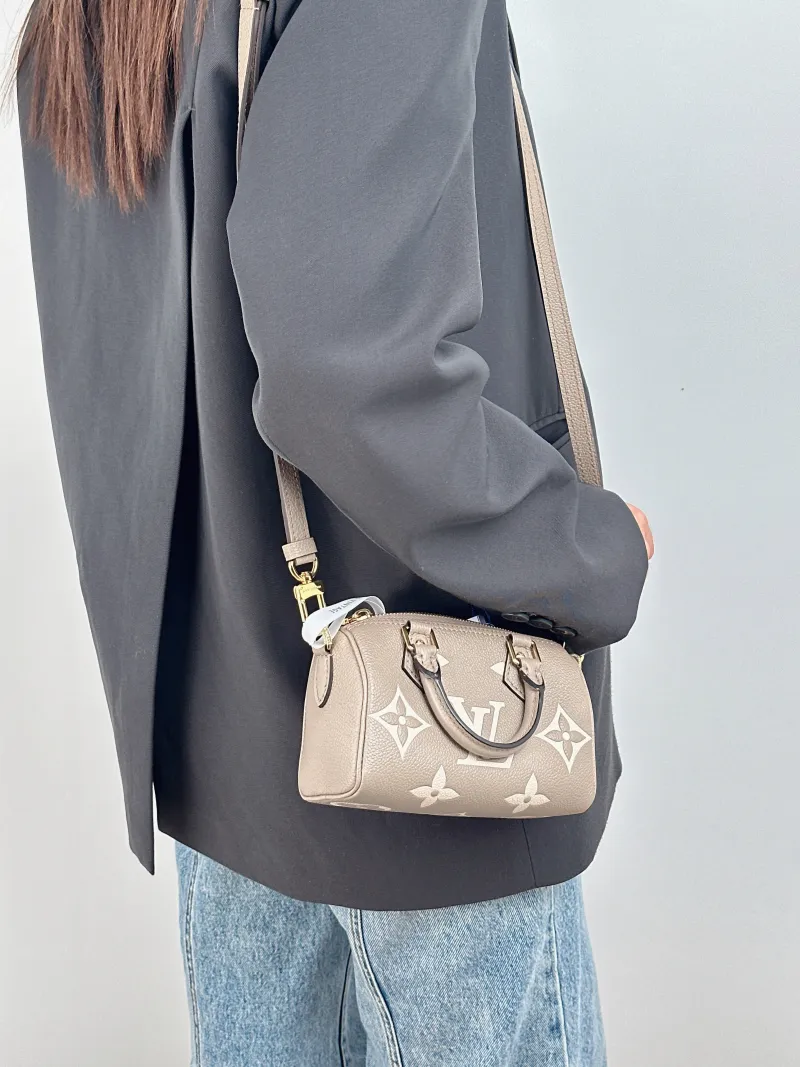 Louis Vuitton Crossbody Bag Speedy Nano · White Monogram Empreinte Embossed Calfskin nano 16 × 7.5 × 10 cm — on-model view 1 of 3