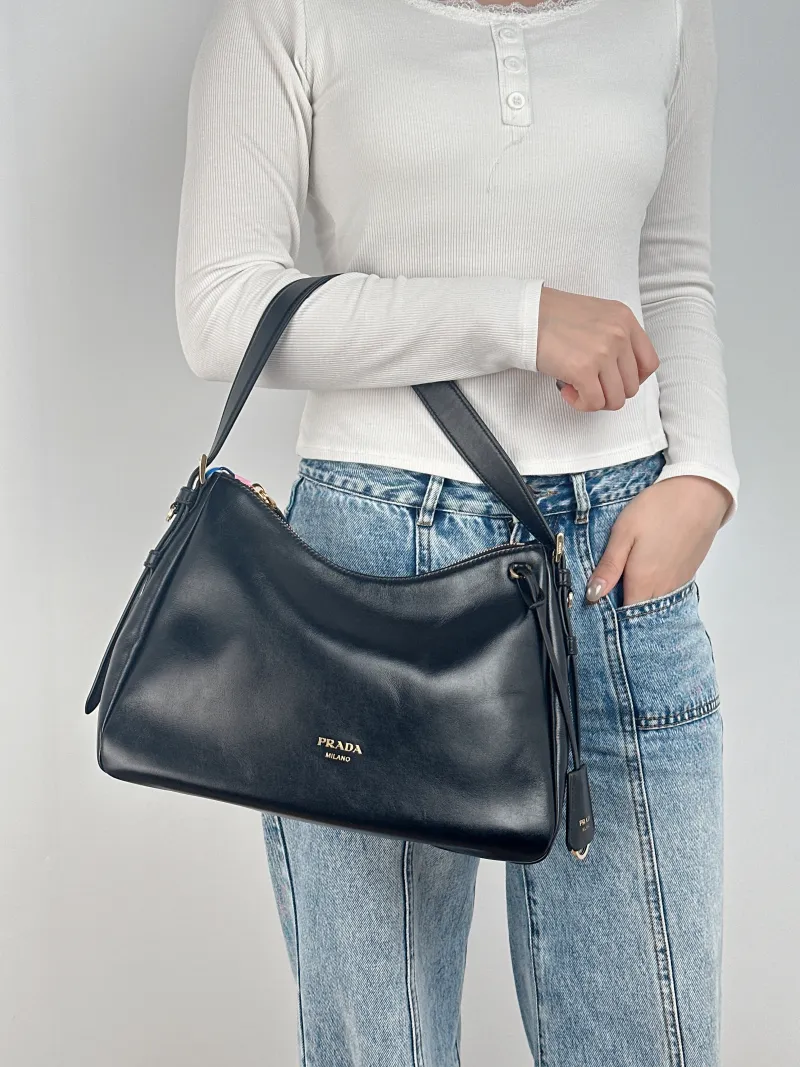 PRADA Shoulder Bag Aimée Black Calfskin 30 × 10 × 22 cm — on-model view 1 of 2
