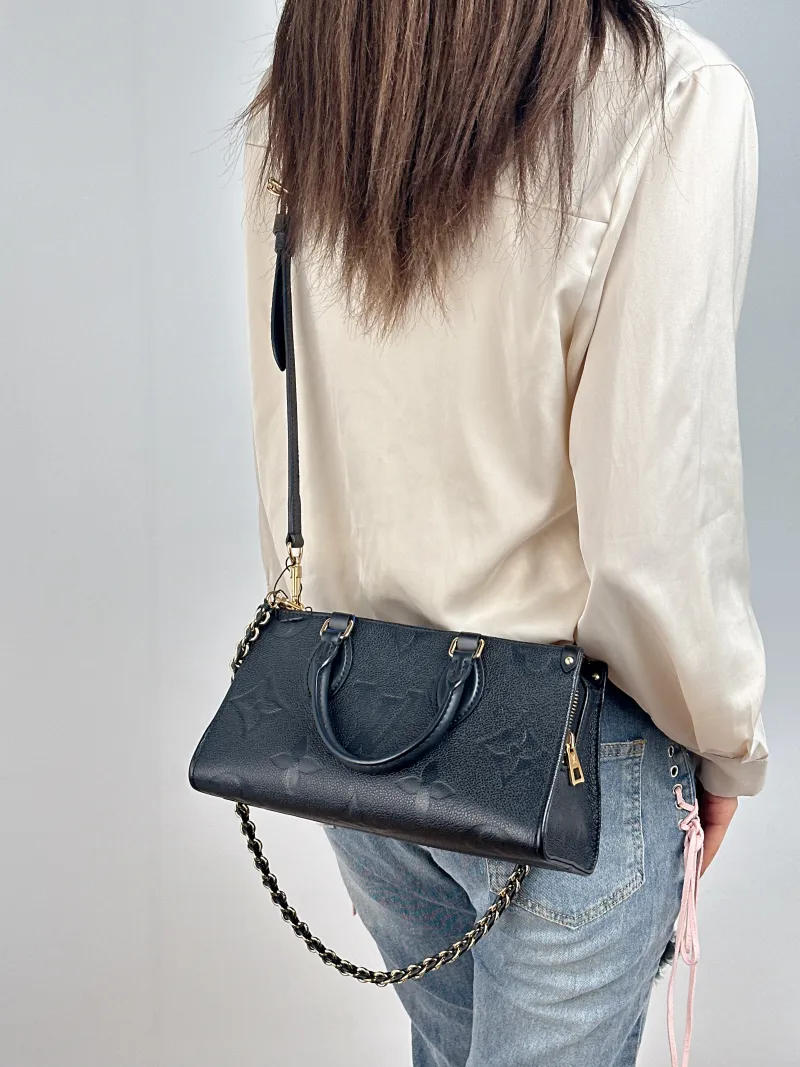 Louis Vuitton Crossbody Bag Onthego East West Two Straps Black Monogram Empreinte Embossed Calfskin Small 25 × 10 × 13 cm — on-model view 2 of 3