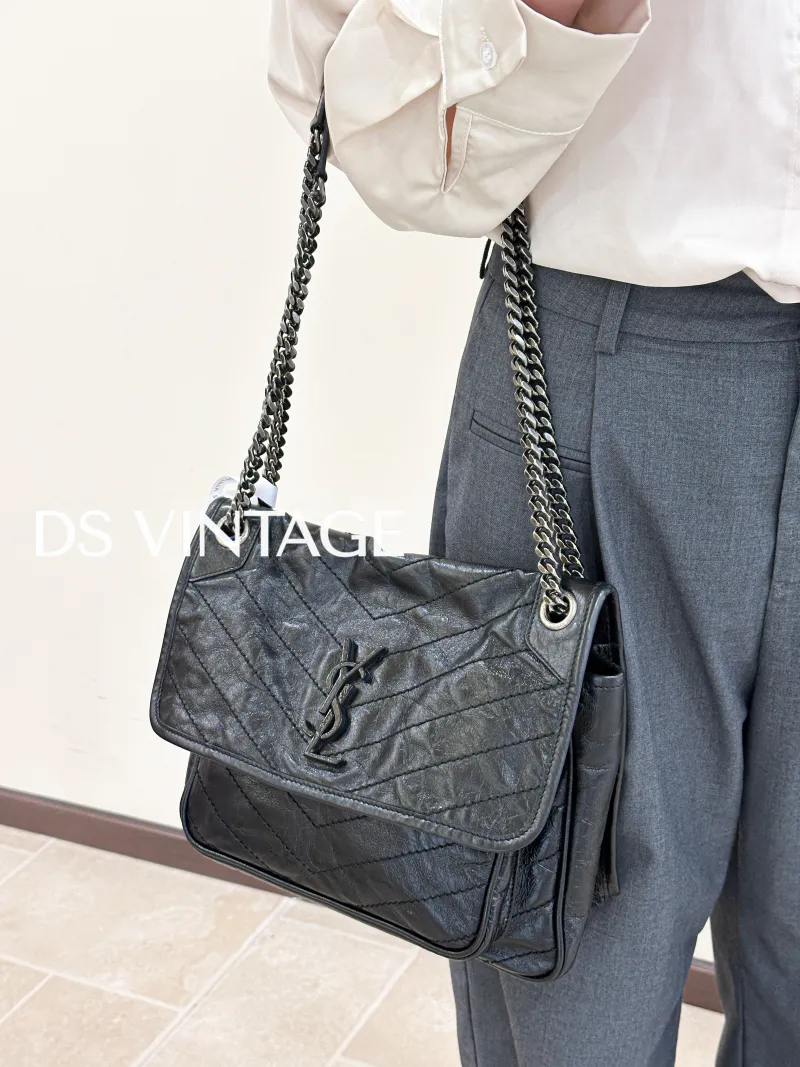 SAINT LAURENT Crossbody Bag Niki Black Waxed Leather Calfskin Medium28 × 8.5 × 20 cm — on-model view 1 of 6