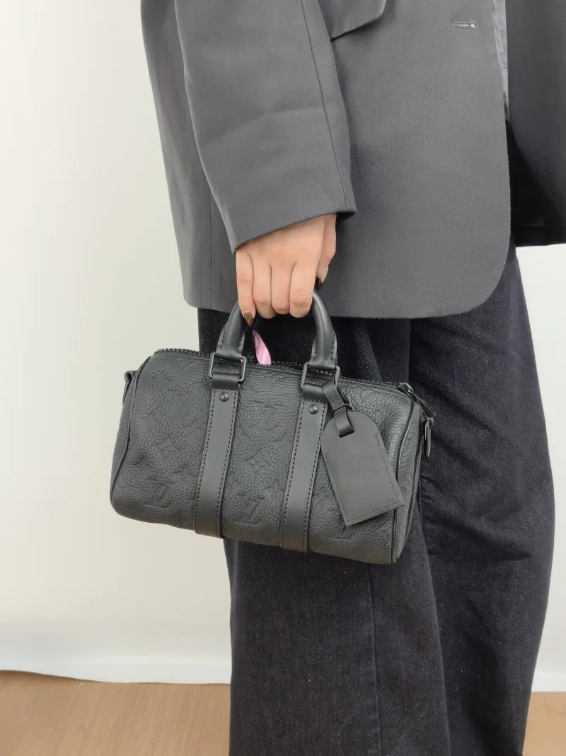 Louis Vuitton Crossbody Bag Keepall 25 Taurillon Monogram Embossed Calfskin Medium 25 × 11 × 15 cm — on-model view 1 of 3