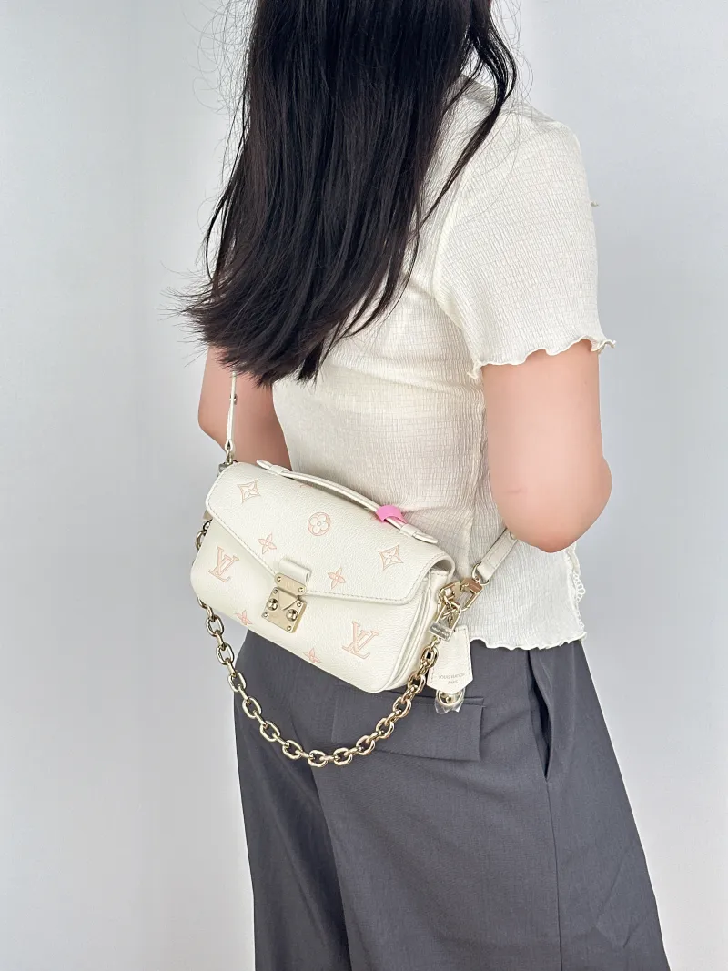 Louis Vuitton Crossbody Bag Pochette Métis East West White · Pink Monogram Empreinte Embossed Calfskin Small21.5 × 6 × 13.5 cm — on-model view 1 of 3