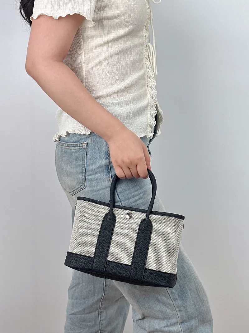Hermès Top Handle Bag Neo Garden 23 Mini Black · Beige Canvas · Negonda Calfskin Mini 23 × 10 × 16 cm G — on-model view 2 of 2