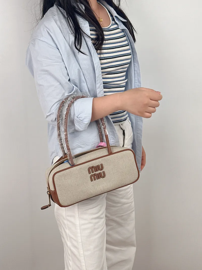 Miumiu Top Handle Bag Beau Brown Canvas · Calfskin Small 28 × 8 × 11.5 cm — on-model view 1 of 2