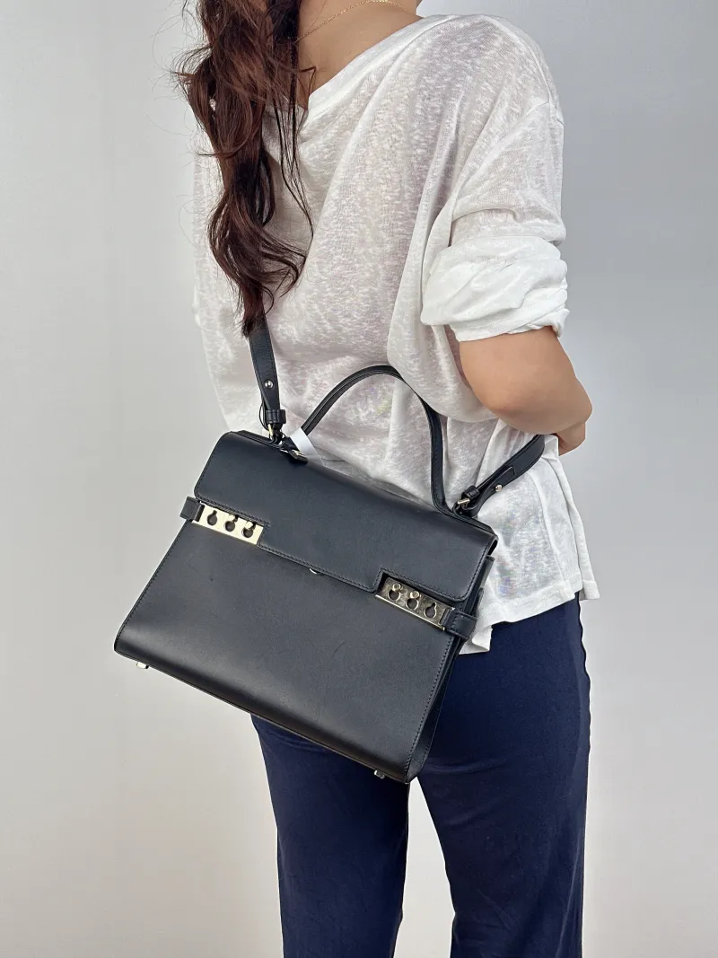 DELVAUX Crossbody Bag Tempete Top Handle Bag Black Calfskin Medium27.5 × 9 × 23 cm — on-model view 1 of 2
