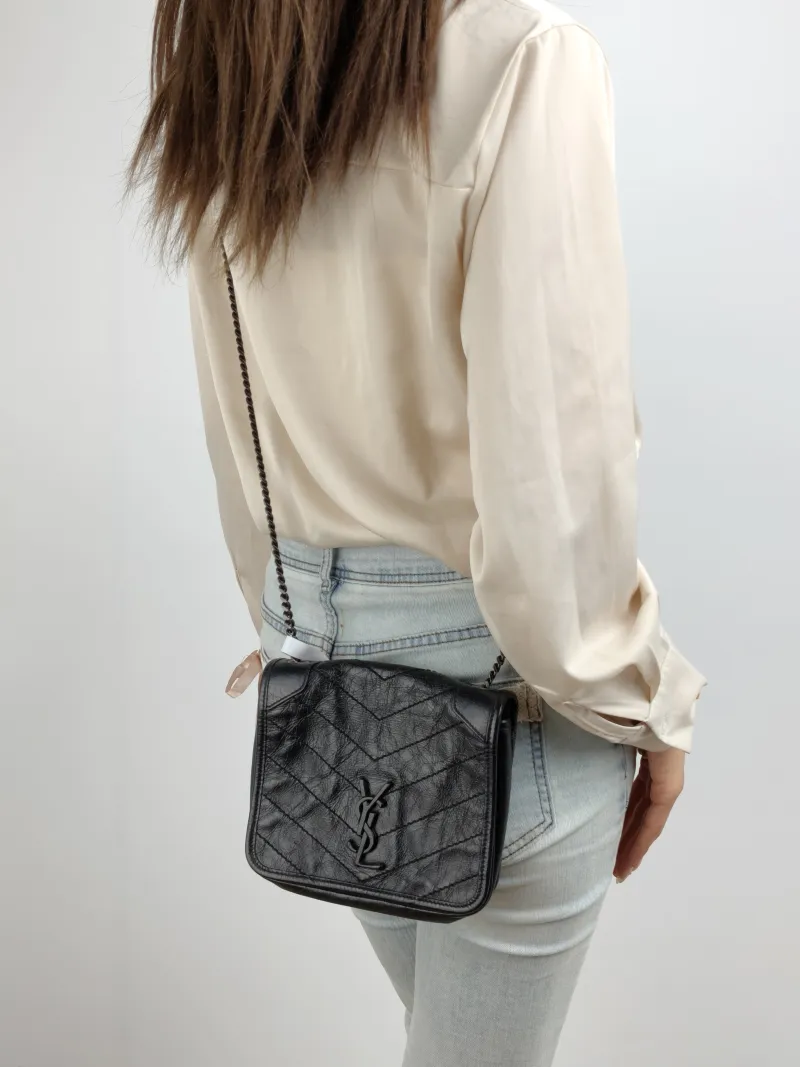 SAINT LAURENT Crossbody Bag Niki Chain Bagwoc Black Waxed Leather Calfskin Mini 19 × 5 × 16 cm — on-model view 2 of 2