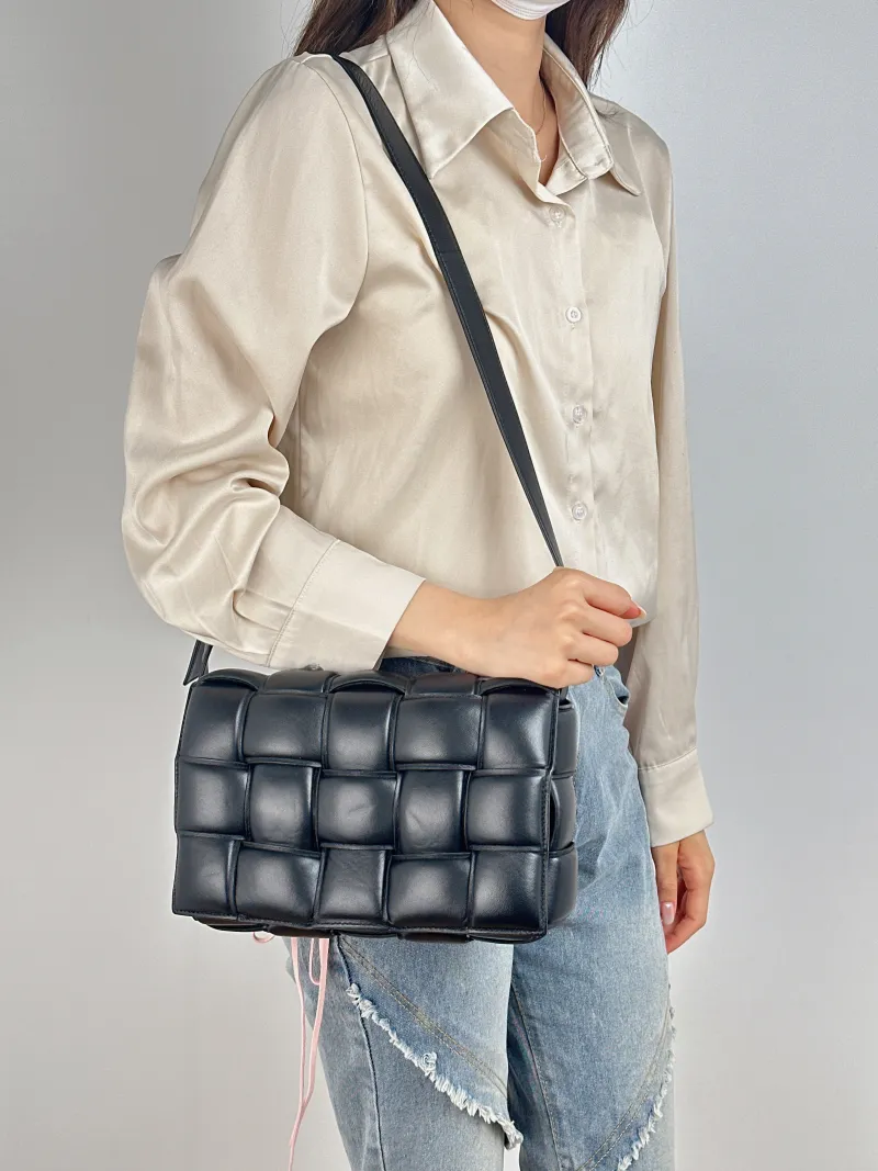 Bottega Veneta Crossbody Bag Padded Cassette Woven Black Lambskin Medium 26 × 8 × 18 cm — on-model view 2 of 2