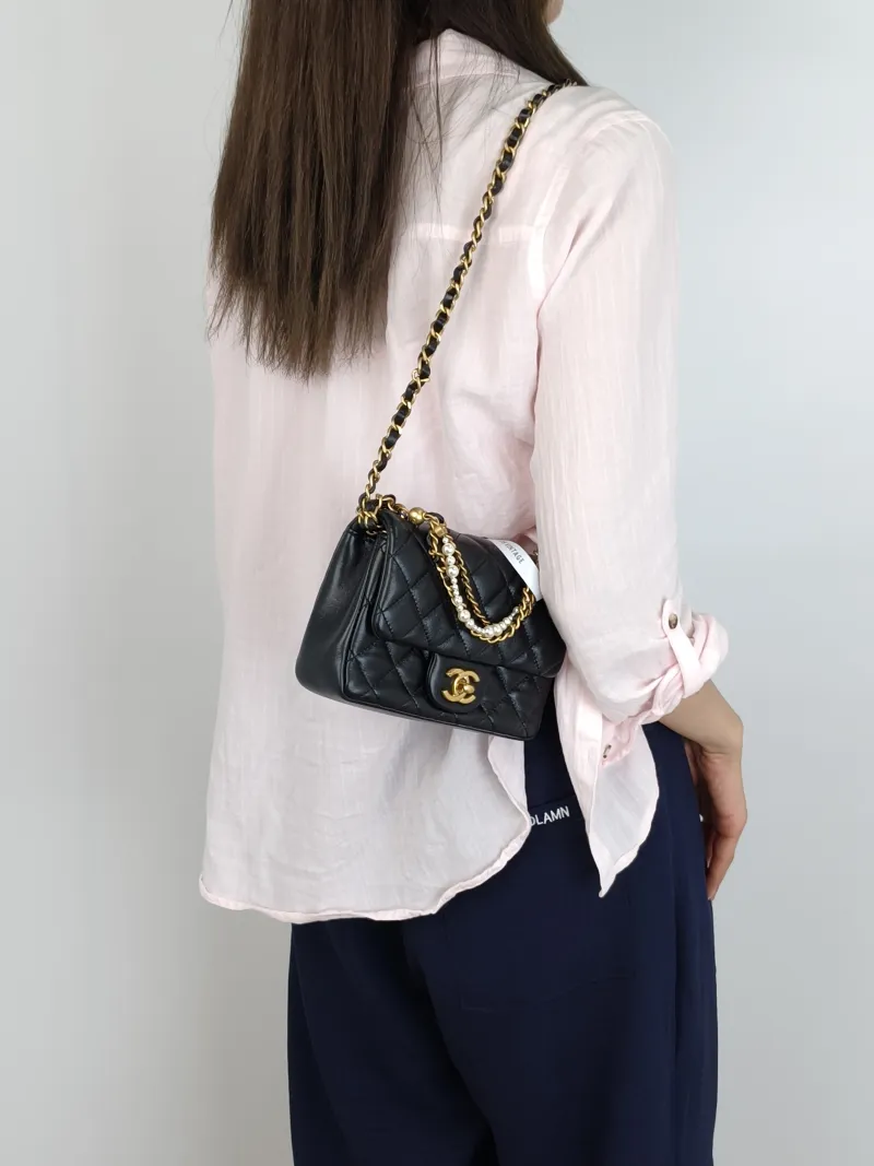 Chanel Crossbody Bag24p Pearl Black Lambskinmini17 × 5 × 12.5 cm — on-model view 1 of 3