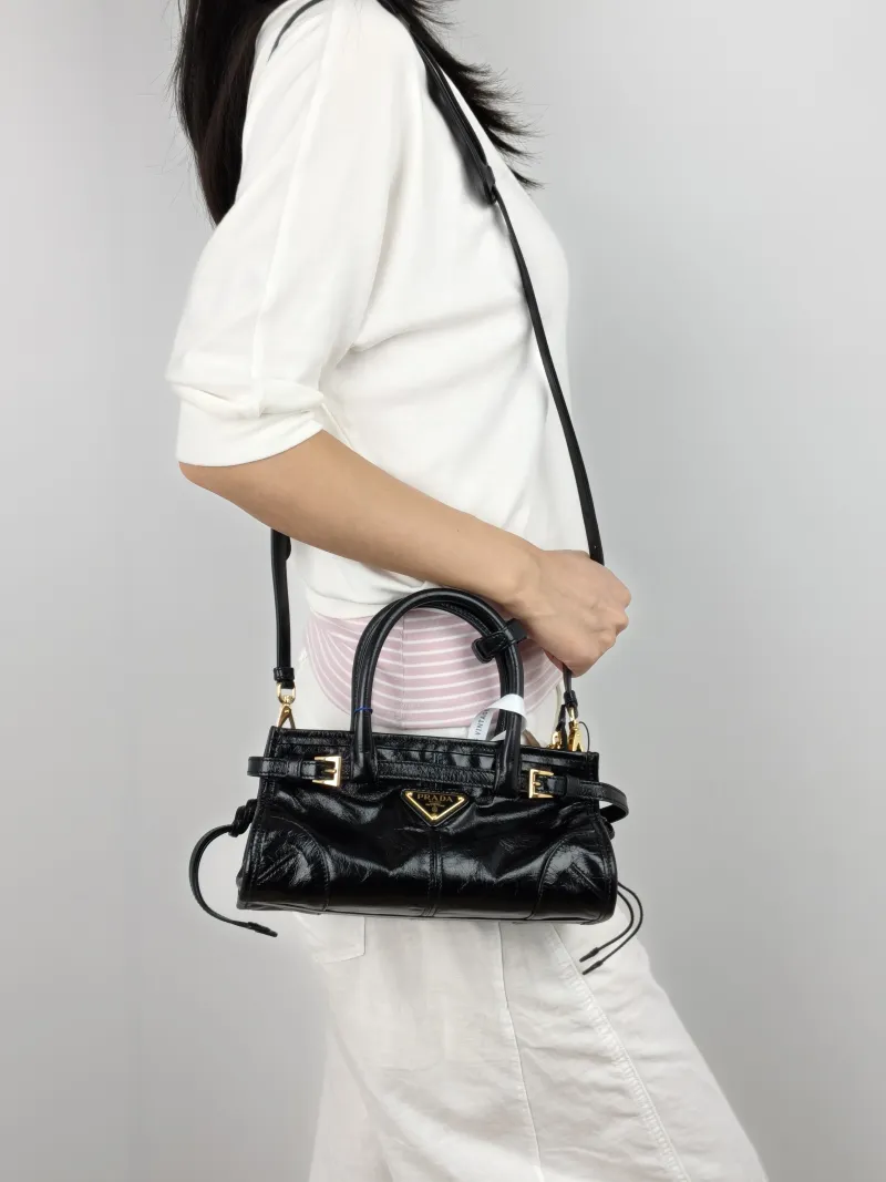 PRADA Shoulder Bag Bonnie Soft Lux Black Waxed Leather Mini 23.5 × 9 × 12 cm — on-model view 3 of 3