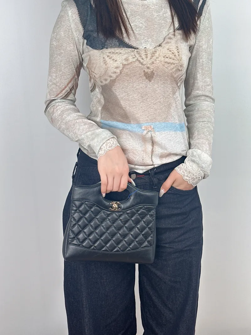 Chanel Crossbody Bag31Bag Black Waxed Leathermini23 × 5.5 × 22 cm — on-model view 1 of 3