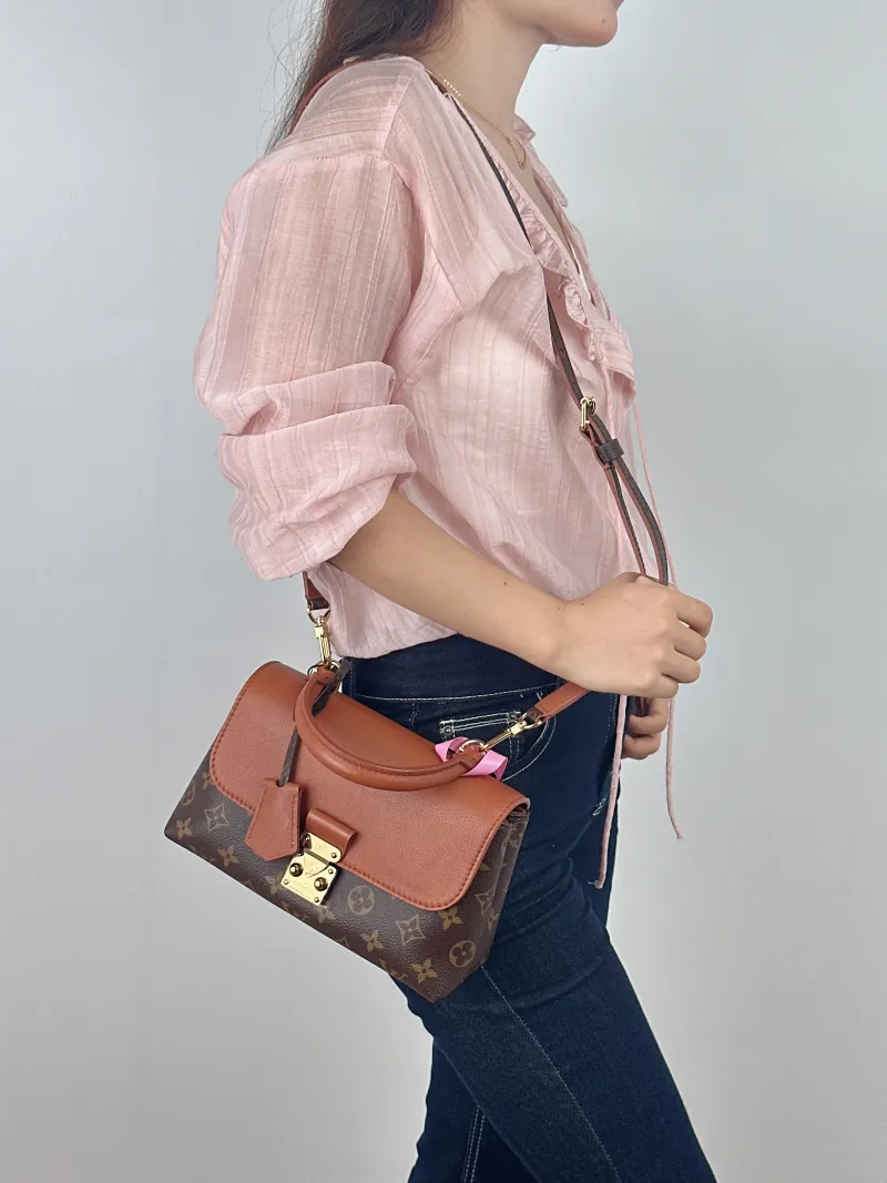 Louis Vuitton Crossbody Bag MADELEINE PVC · Calfskin BB 24.5 × 8 × 16 cm — on-model view 1 of 2