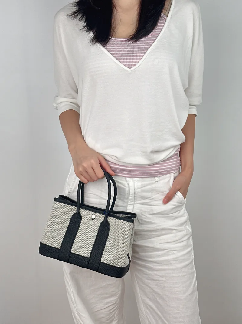 Hermès Top Handle Bag Neo Garden 23 Mini Black · Beige Canvas · Negonda Calfskin Mini 23 × 10 × 16 cm G — on-model view 1 of 2