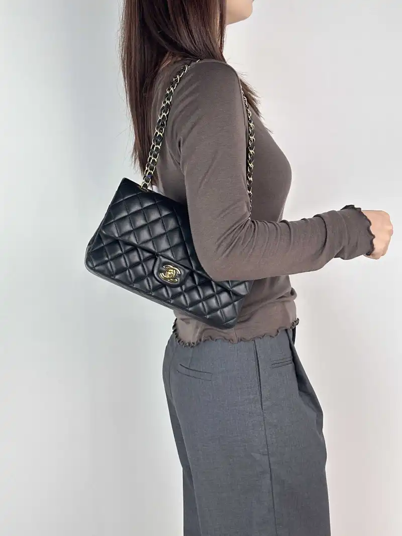 Chanel Crossbody Bag Classic Flap CF Black Lambskin Medium 25.5 × 6.5 × 15.5 cm — on-model view 1 of 2