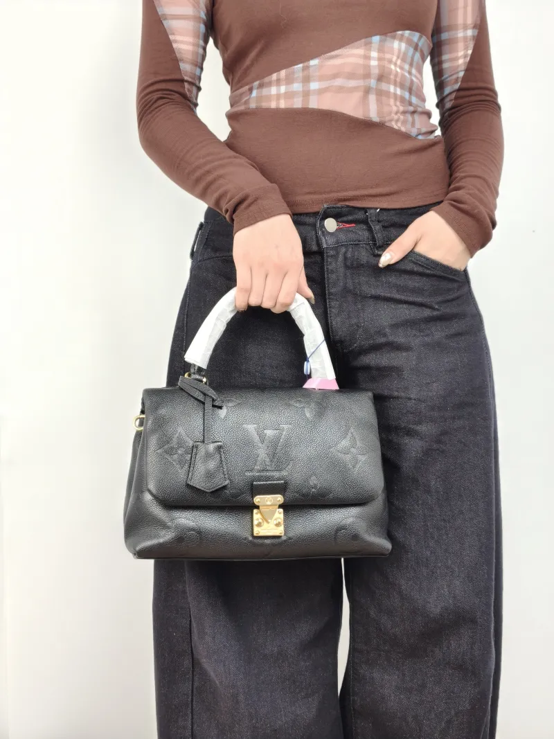 Louis Vuitton Crossbody Bag MADELEINE Black Monogram Empreinte Embossed Calfskin Medium 30 × 11 × 19.5 cm — on-model view 2 of 3
