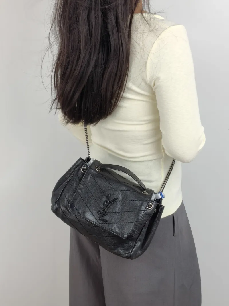 SAINT LAURENT Crossbody Bag NOLITA Black Lambskin Small 22 × 13 × 17.5 cm — on-model view 2 of 2