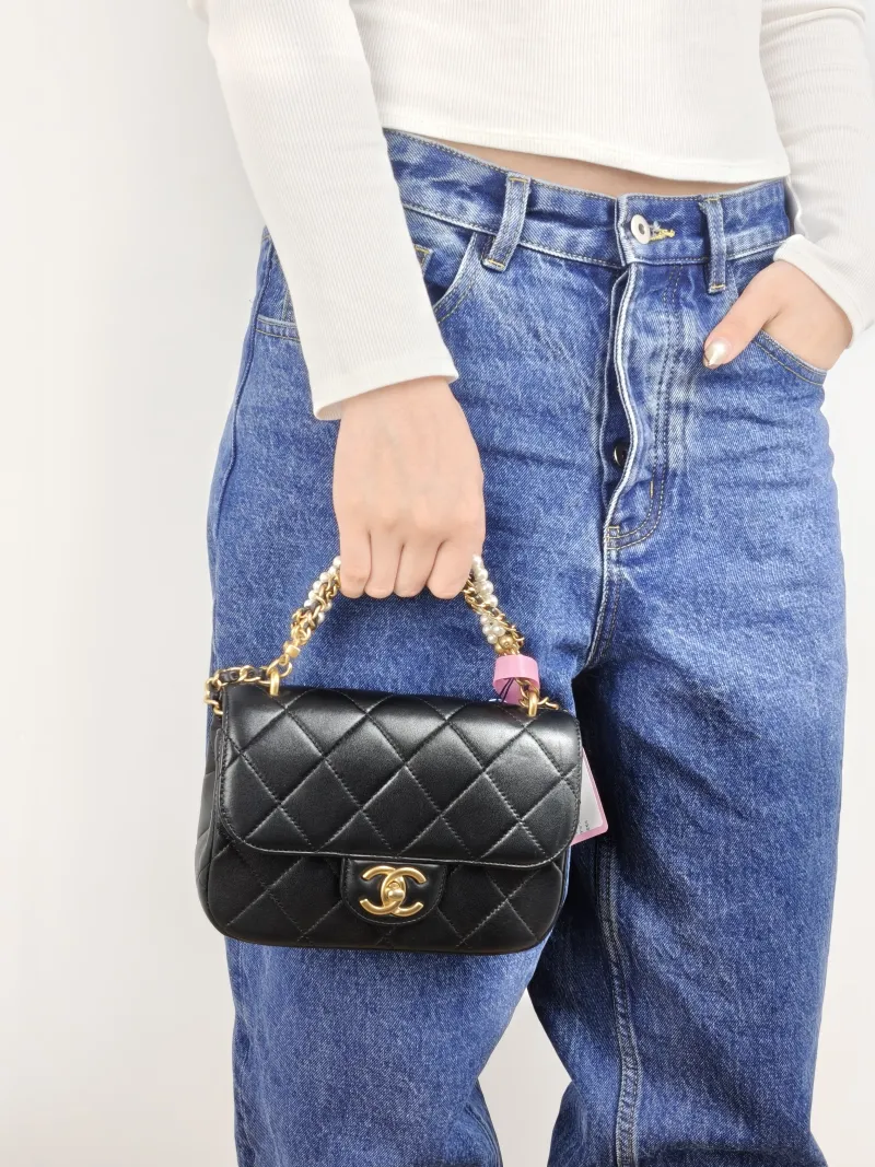 Chanel Crossbody Bag Pearl Black Lambskin Small 19 × 6 × 14 cm — on-model view 1 of 3