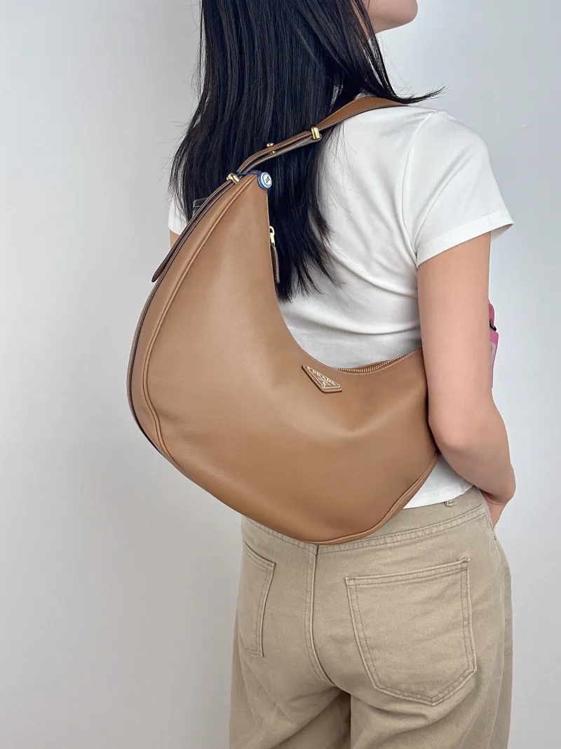 PRADA Shoulder Bag Arqué Brown Calfskin Large 35 × 8 × 22 cm — on-model view 1 of 2